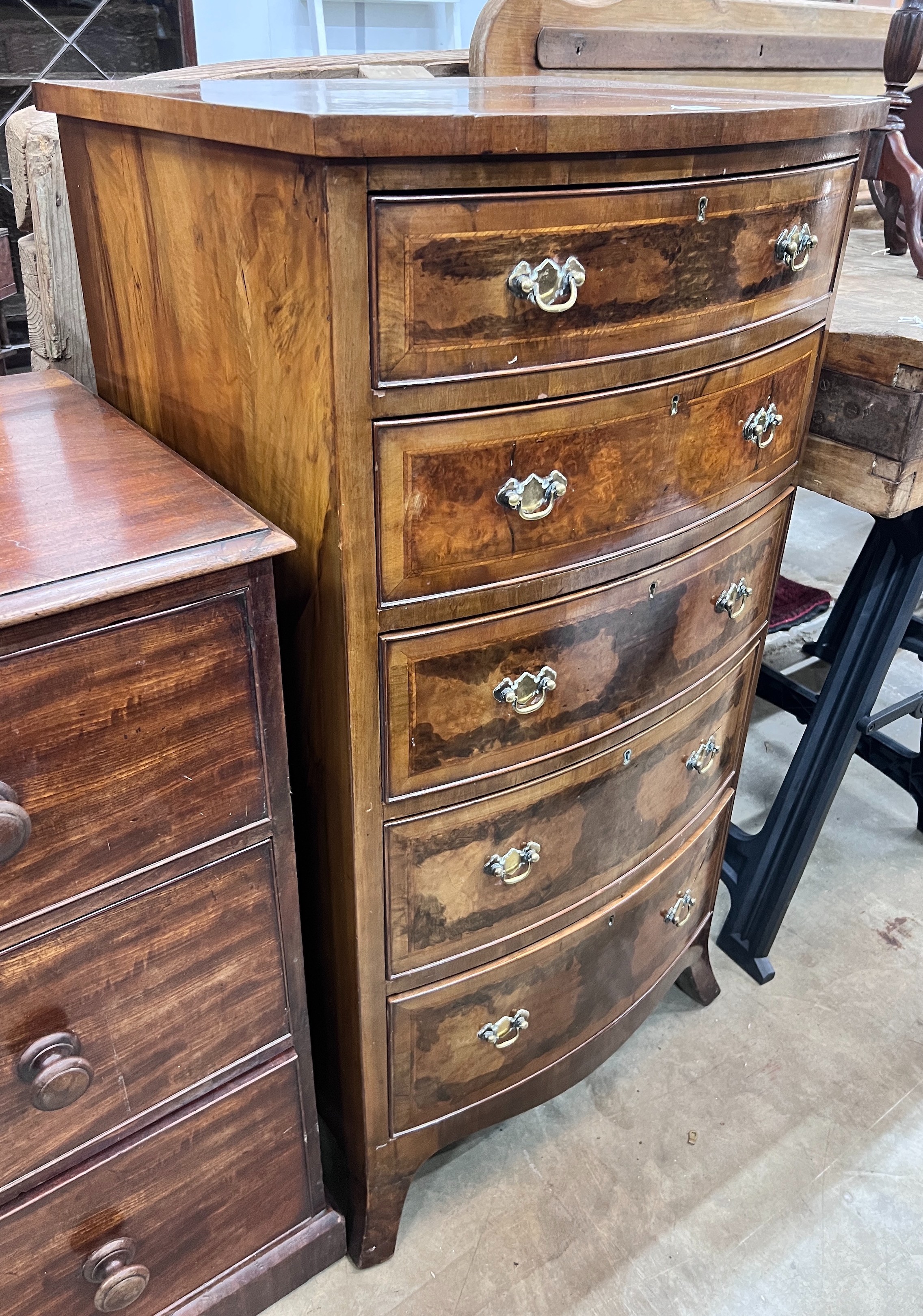A Queen Anne revival feather banded walnut bowfront five drawer chest, width 61cm, depth 52cm, height 116cm *Please note the sale commences at 9am.